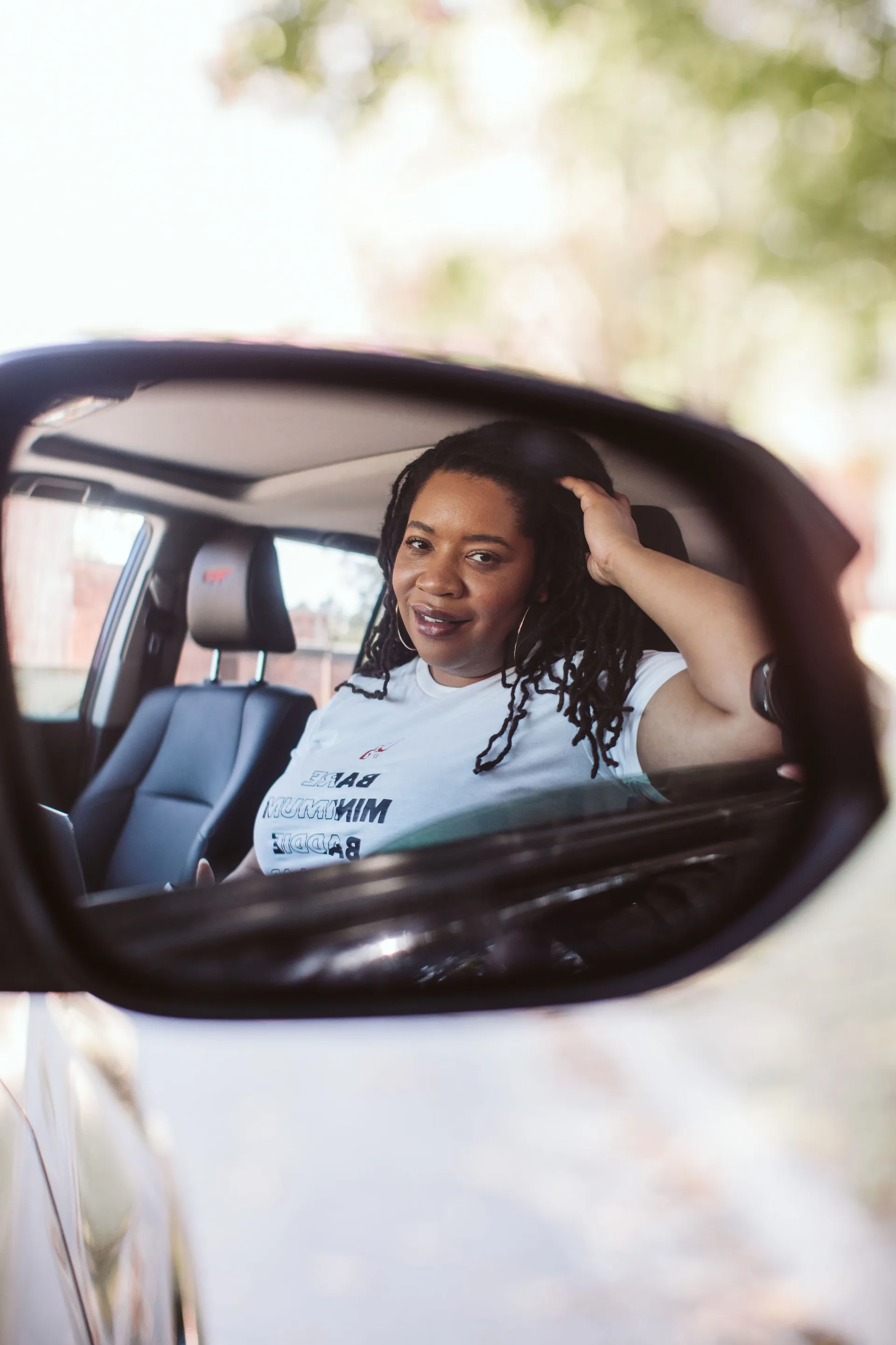 Dr. Marvette Lacy smiling from the driver's seat of a car in daylight